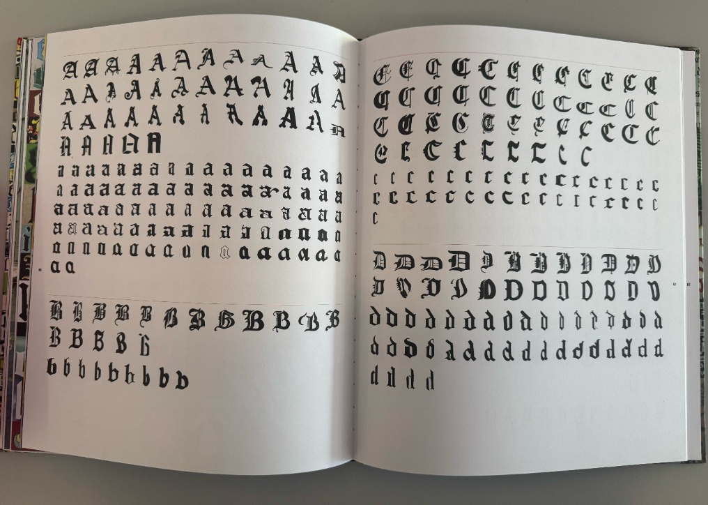 Hand-drawn blackletter calligraphy sketches in a process notebook