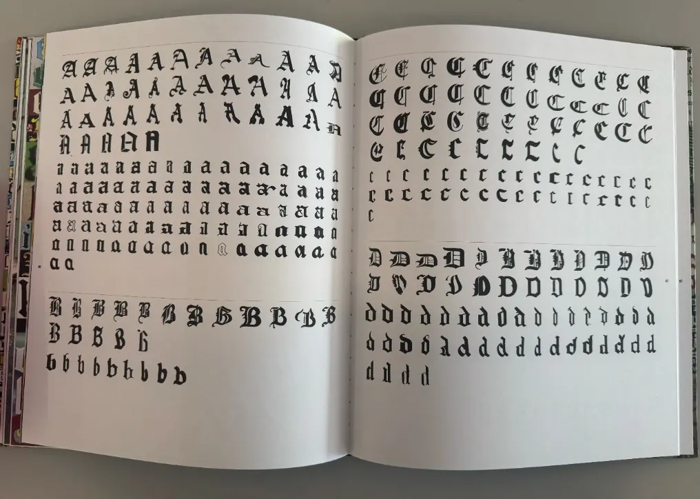 Hand-drawn blackletter calligraphy sketches in a process notebook